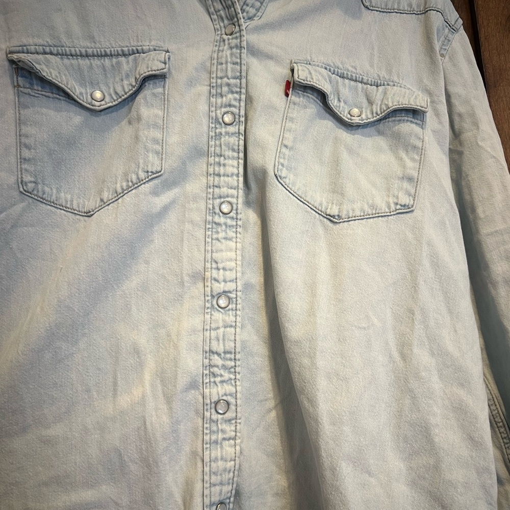 Light Blue Denim Levi Shirt. Woman’s size large. Pearl, snap buttons.